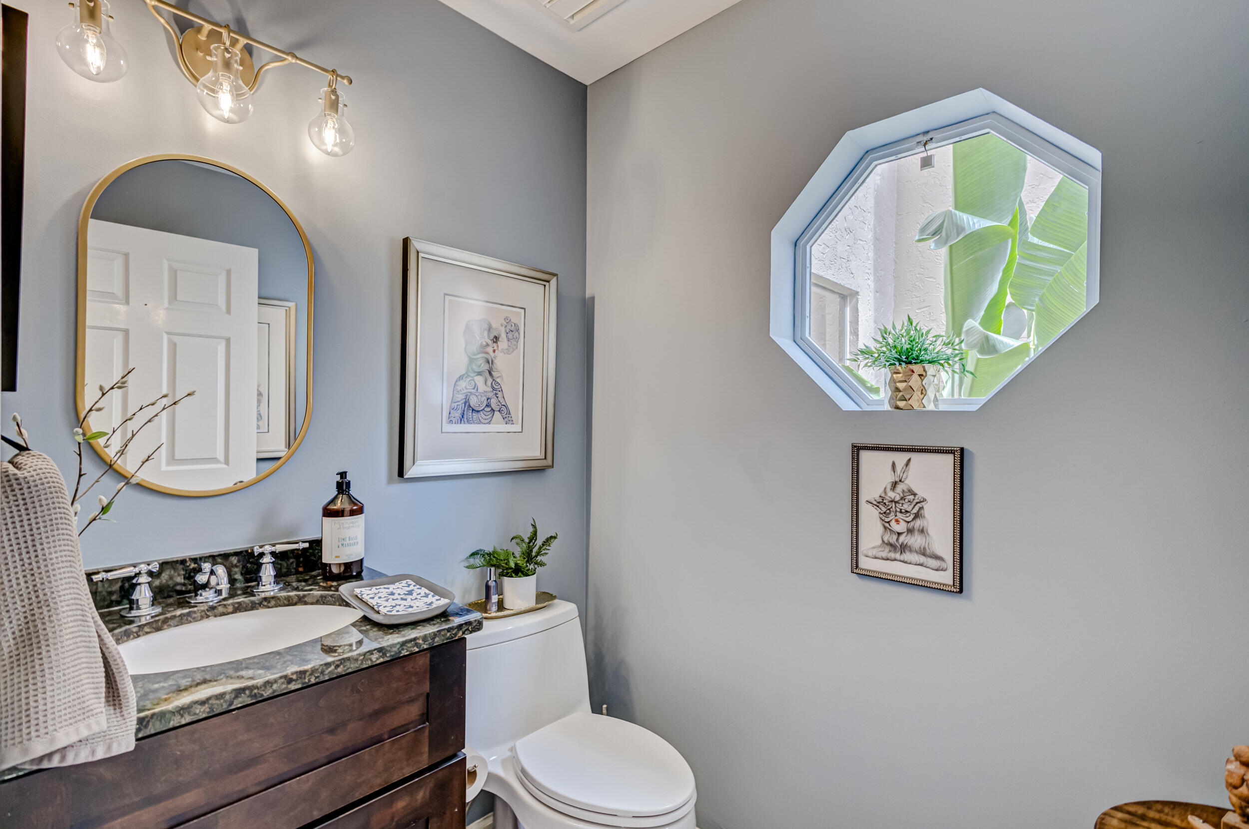 3546 Lantern Bay Drive Jupiter, FL 33477 - Photo 20 of 25 a bathroom with a granite countertop toilet a mirror and vanity