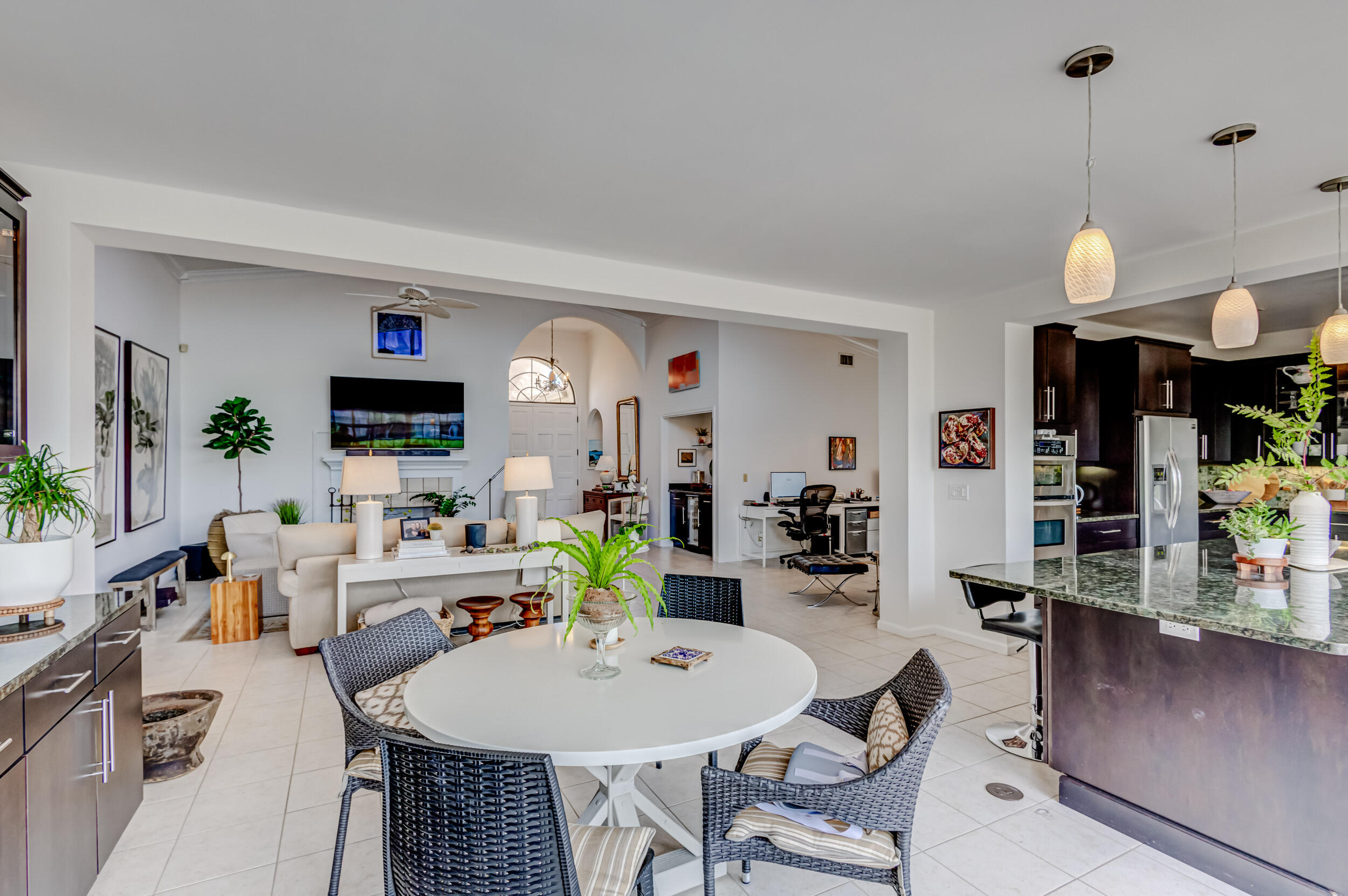 3546 Lantern Bay Drive Jupiter, FL 33477 - Photo 7 of 25 a view of a dining room and livingroom with furniture wooden floor and a rug
