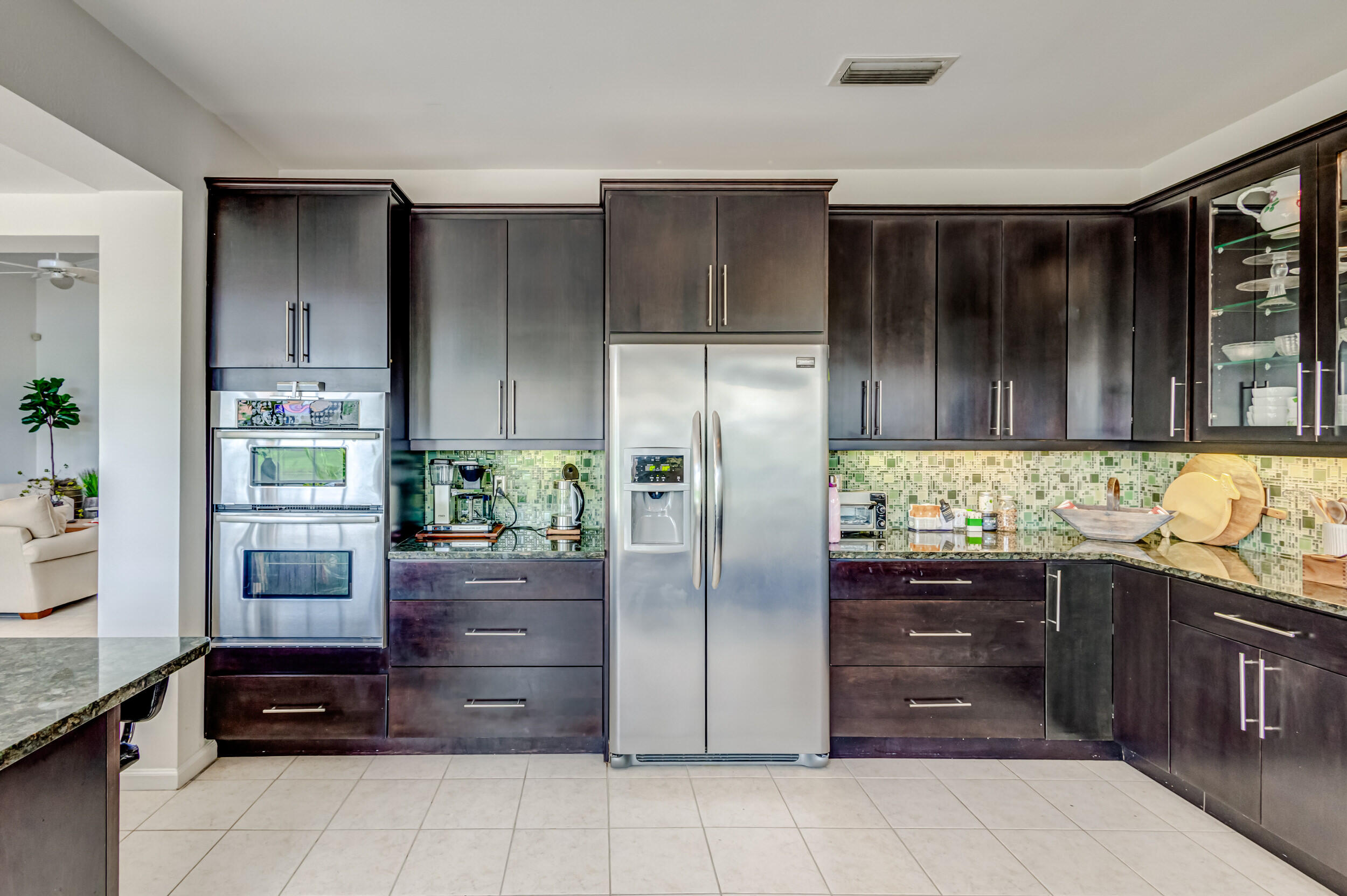 3546 Lantern Bay Drive Jupiter, FL 33477 - Photo 9 of 25 a kitchen with stainless steel appliances granite countertop a refrigerator and a stove