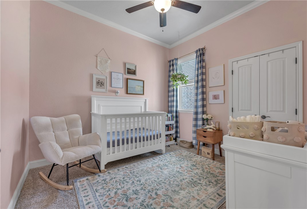 8312 Raintree Drive College Station, TX 77845 - Photo 20 of 30 Carpeted room featuring a ceiling fan with integrated lighting, crown molding, a window with blinds, and white paneled double doors
