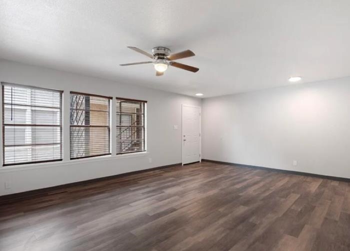 1283 East Raines Road Memphis, TN 38116 - Photo 4 of 23 a view of an empty room with a window and wooden floor