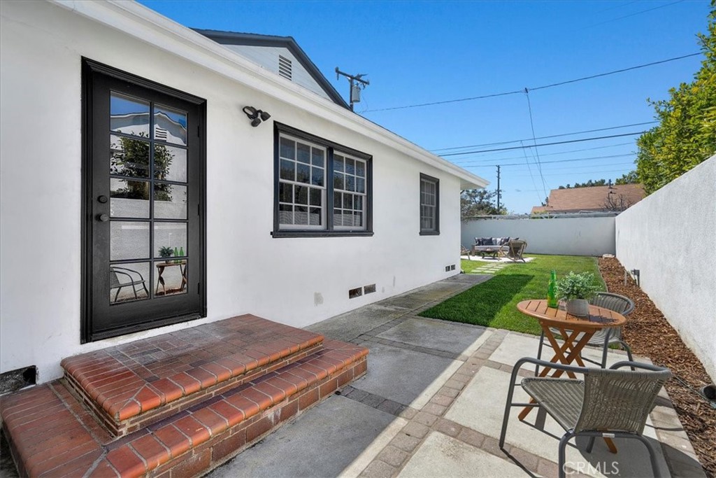 15519 Roselle Avenue Lawndale, CA 90260 - Photo 25 of 28 a patio with table and chairs and potted plants