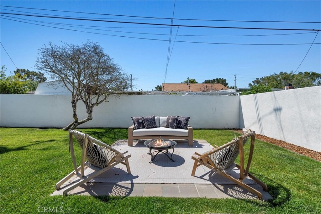 15519 Roselle Avenue Lawndale, CA 90260 - Photo 26 of 28 a view of a patio with table and chairs under an umbrella