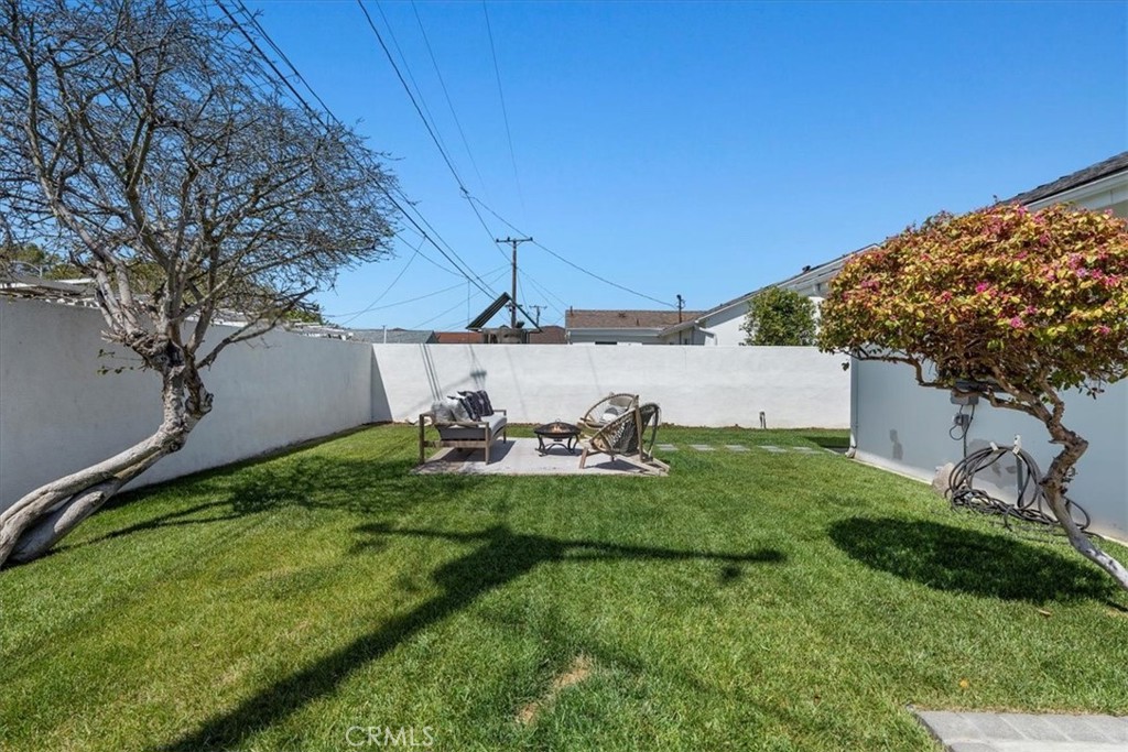 15519 Roselle Avenue Lawndale, CA 90260 - Photo 28 of 28 a view of a backyard with table and chairs and a fire pit