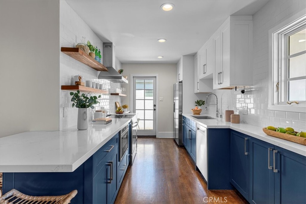 15519 Roselle Avenue Lawndale, CA 90260 - Photo 7 of 28 a kitchen with stainless steel appliances granite countertop sink stove and cabinets