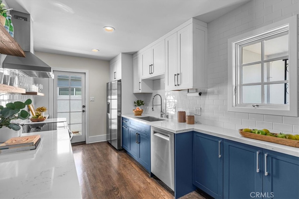 15519 Roselle Avenue Lawndale, CA 90260 - Photo 9 of 28 a kitchen with stainless steel appliances granite countertop a stove a sink dishwasher and a refrigerator with wooden floor