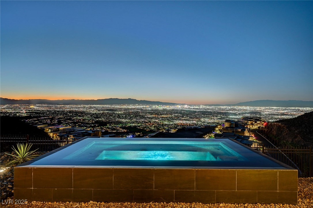 607 Grand Rim Drive Henderson, NV 89012 - Photo 1 of 30 View of pool with an in-ground hot tub and a mountain view