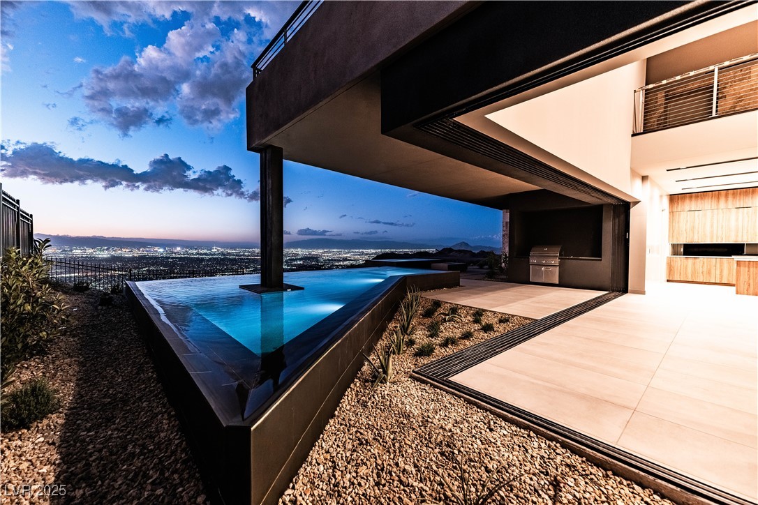 607 Grand Rim Drive Henderson, NV 89012 - Photo 21 of 30 Patio terrace at dusk with exterior kitchen and a patio