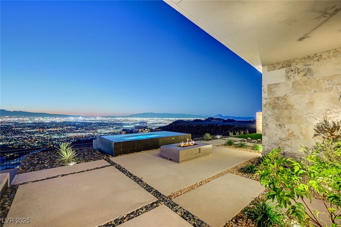 607 Grand Rim Drive Henderson, NV 89012 - Photo 24 of 30 View of patio / terrace featuring a fire pit and a mountain view
