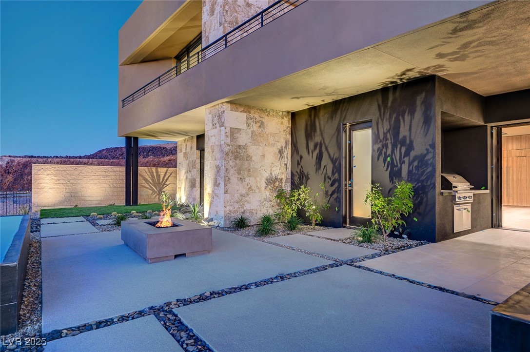 607 Grand Rim Drive Henderson, NV 89012 - Photo 25 of 30 Patio / terrace with a fire pit, exterior kitchen, and a mountain view