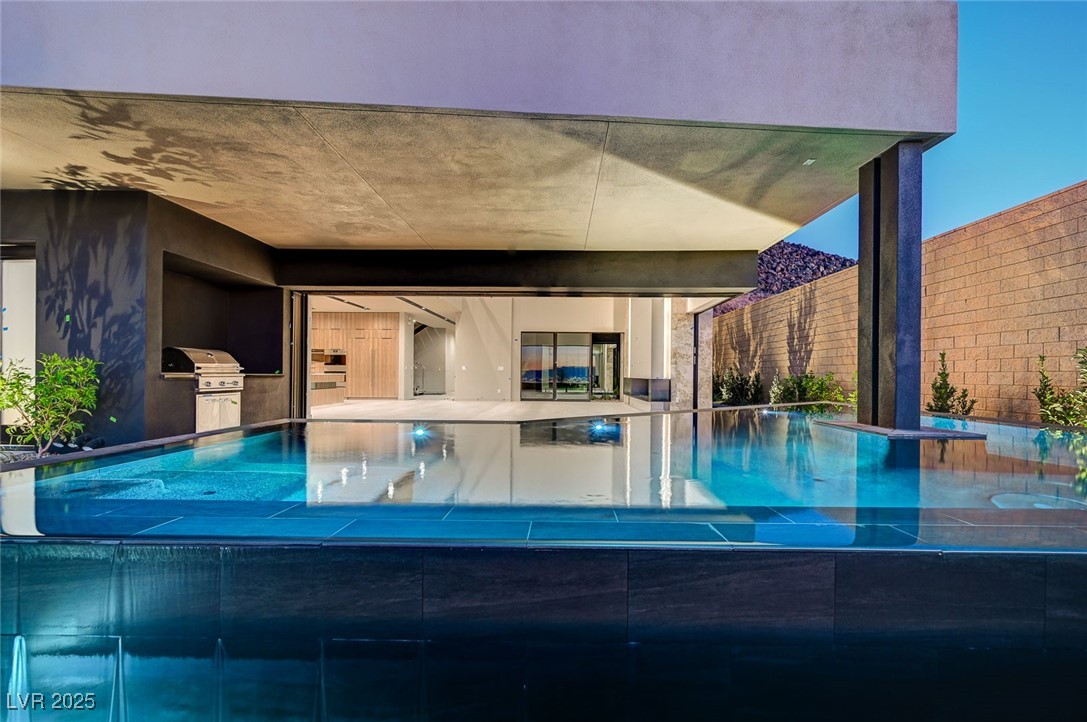 607 Grand Rim Drive Henderson, NV 89012 - Photo 4 of 30 Outdoor pool with a patio and exterior kitchen