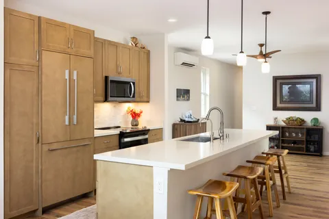 a kitchen with stainless steel appliances a stove a refrigerator and a sink
