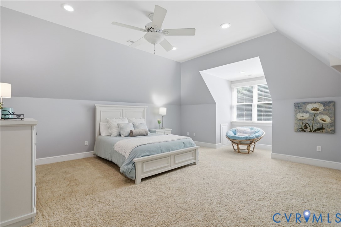 12123 Deer Ridge Court Ashland, VA 23005 - Photo 49 of 63 a spacious bedroom with a bed a table and chair