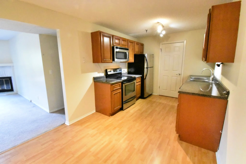 1330 Brook Street, Unit M St. Charles, IL 60174 - Photo 3 of 11 a kitchen with stainless steel appliances granite countertop a sink stove and refrigerator