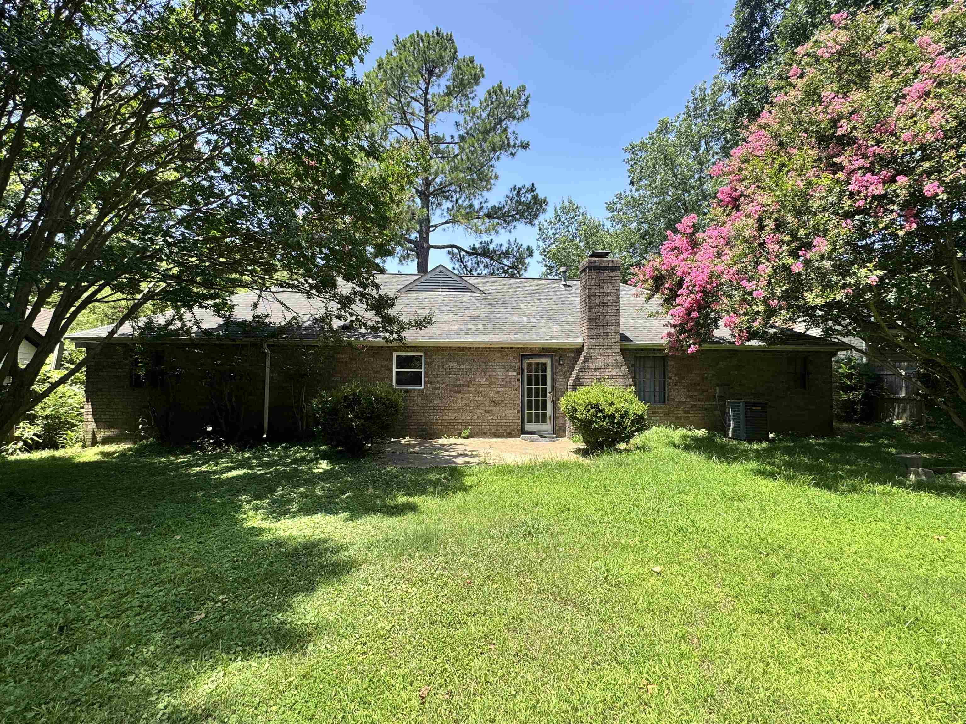4334 Timber Rise Road Memphis, TN 38125 - Photo 17 of 18 Brick exterior featuring a gabled roofline and multiple mature trees