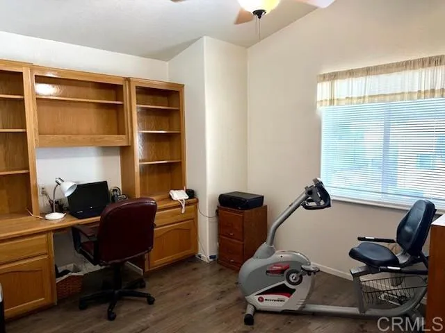 a view of a workspace with furniture and a window