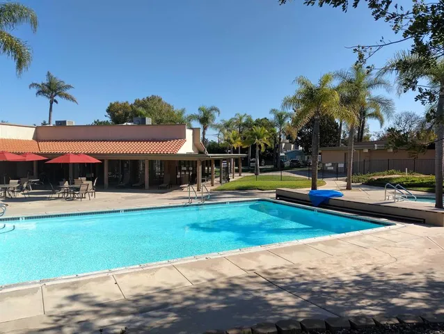 a front view of a house with a garden and potted plants