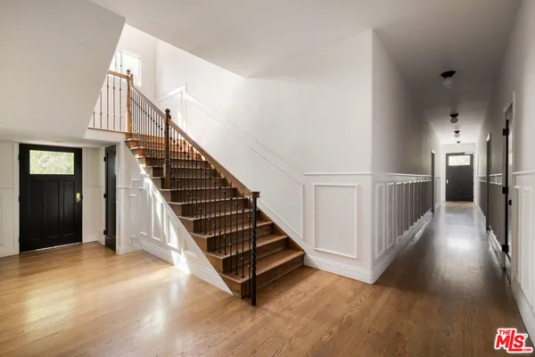 a view of a room with wooden floor and windows