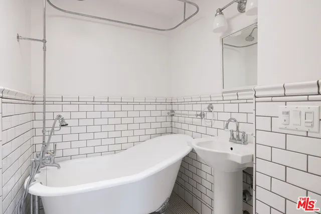a bathroom with a bathtub and shower