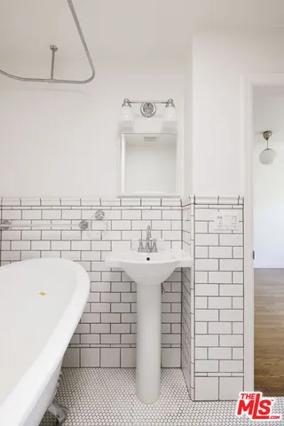 a bathroom with a toilet a sink and bathtub