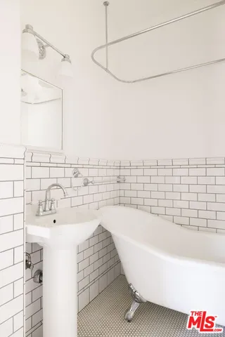a white bath tub sitting next to a white roof