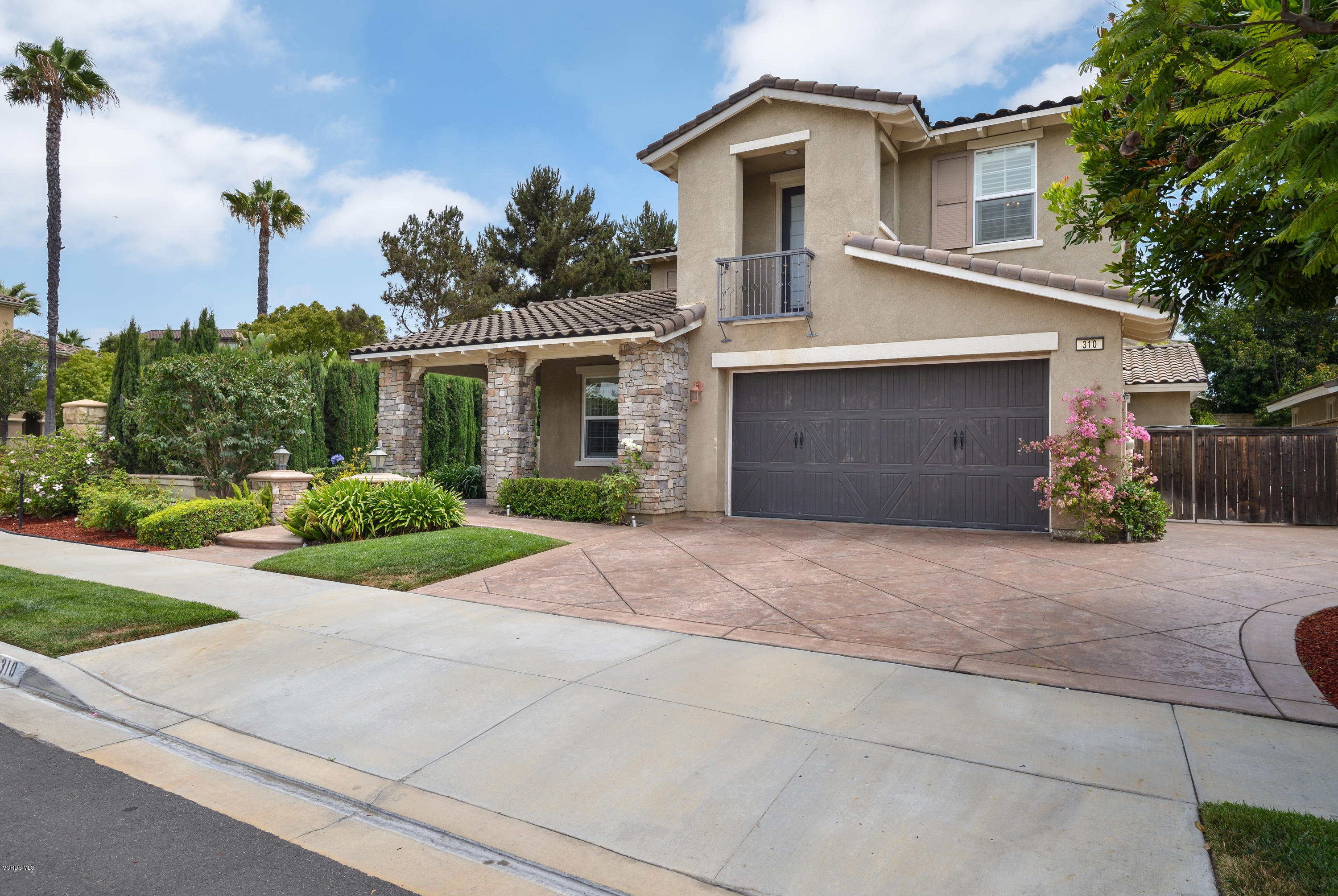 310 Spring Park Road Camarillo, CA 93012 - Photo 1 of 48 a front view of a house with a yard and a garage