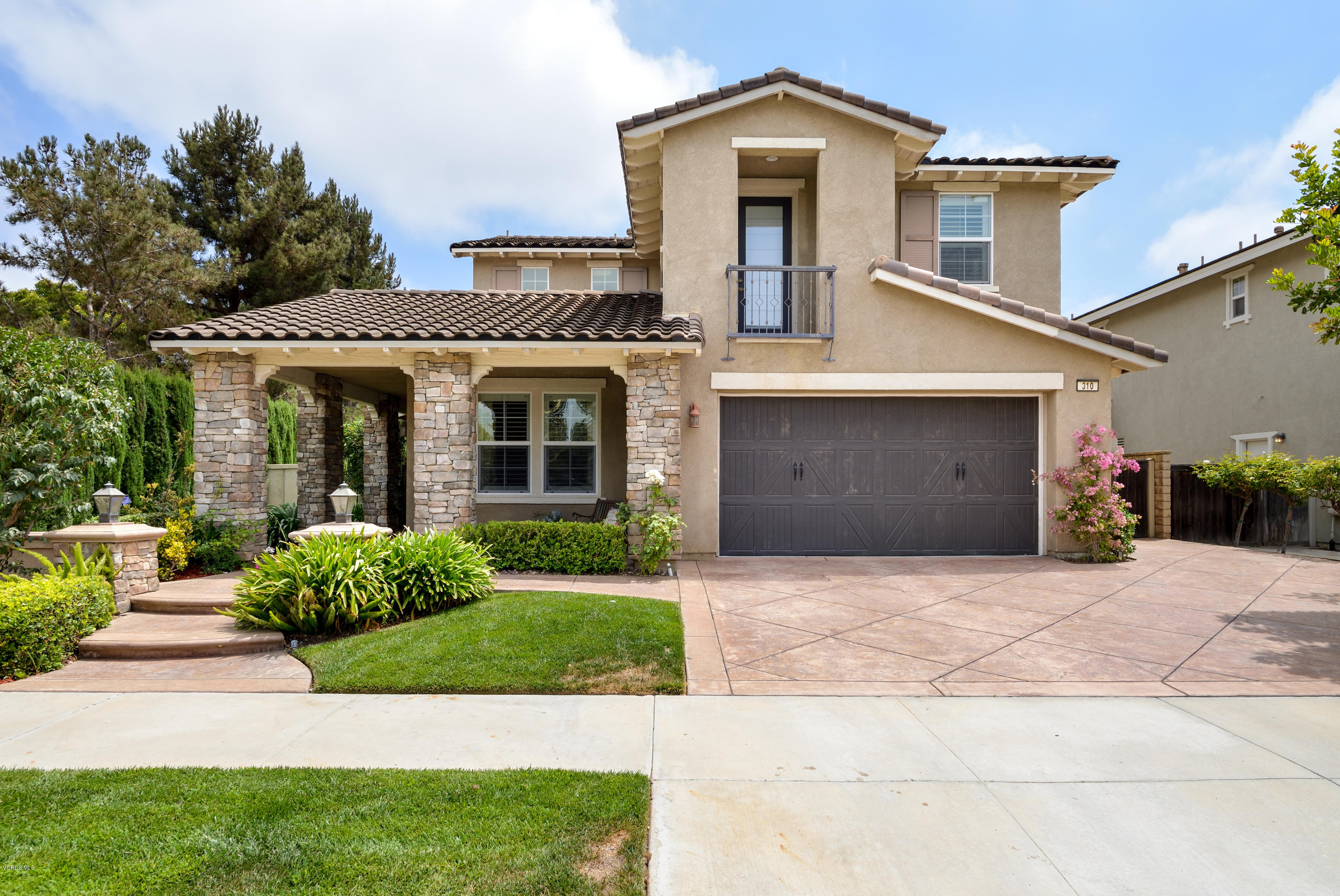 310 Spring Park Road Camarillo, CA 93012 - Photo 2 of 48 a front view of a house with a yard and garage