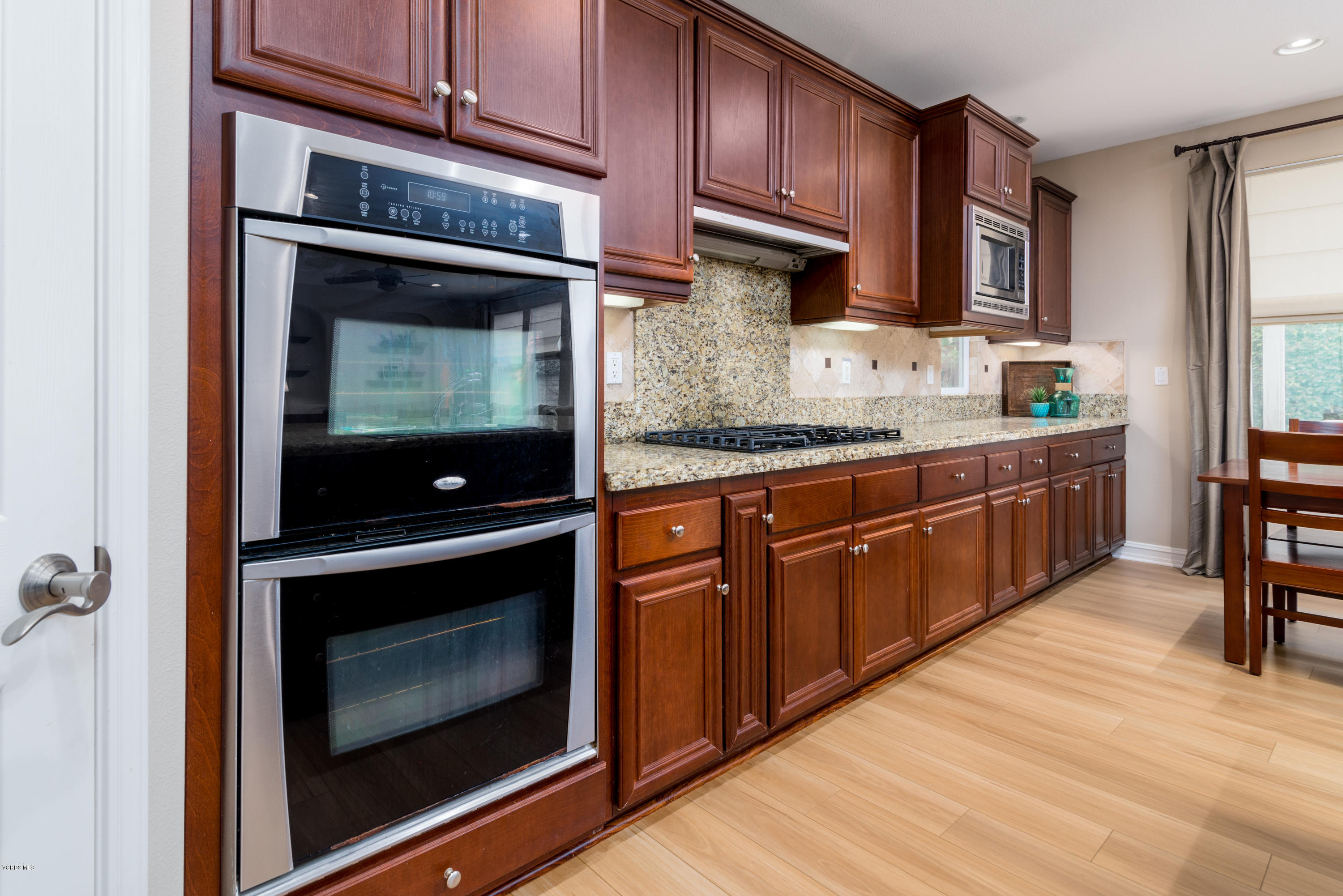 310 Spring Park Road Camarillo, CA 93012 - Photo 22 of 48 a kitchen with stainless steel appliances granite countertop wooden cabinets a stove and a sink