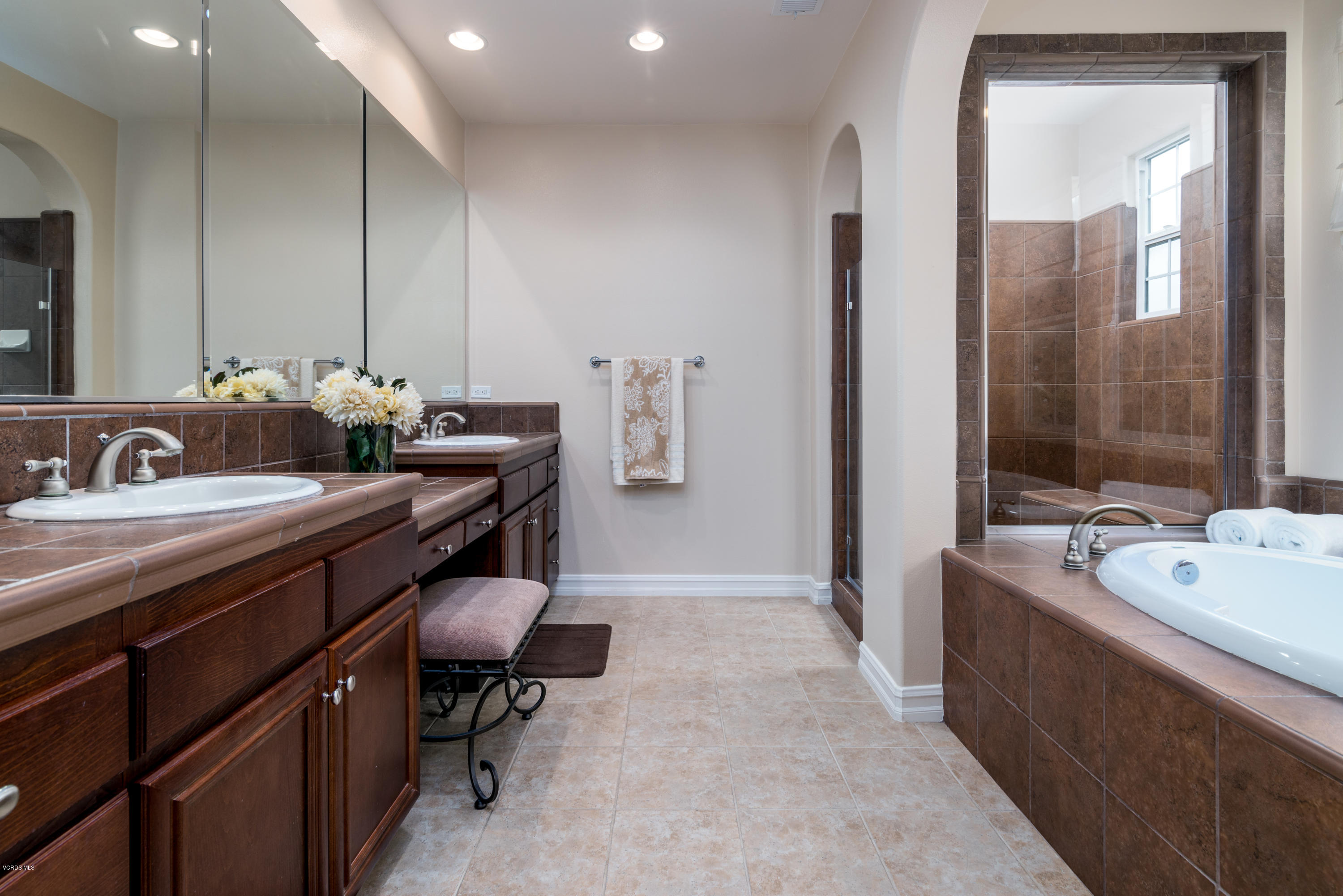 310 Spring Park Road Camarillo, CA 93012 - Photo 40 of 48 a en suite bathroom with a double vanity sink a mirror and a bathtub