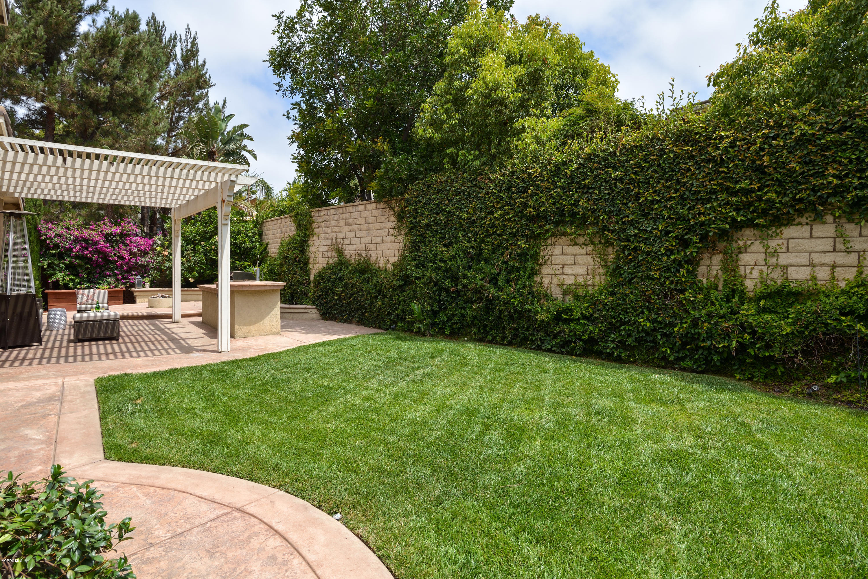 310 Spring Park Road Camarillo, CA 93012 - Photo 5 of 48 a view of a patio with table and chairs potted plants and large tree
