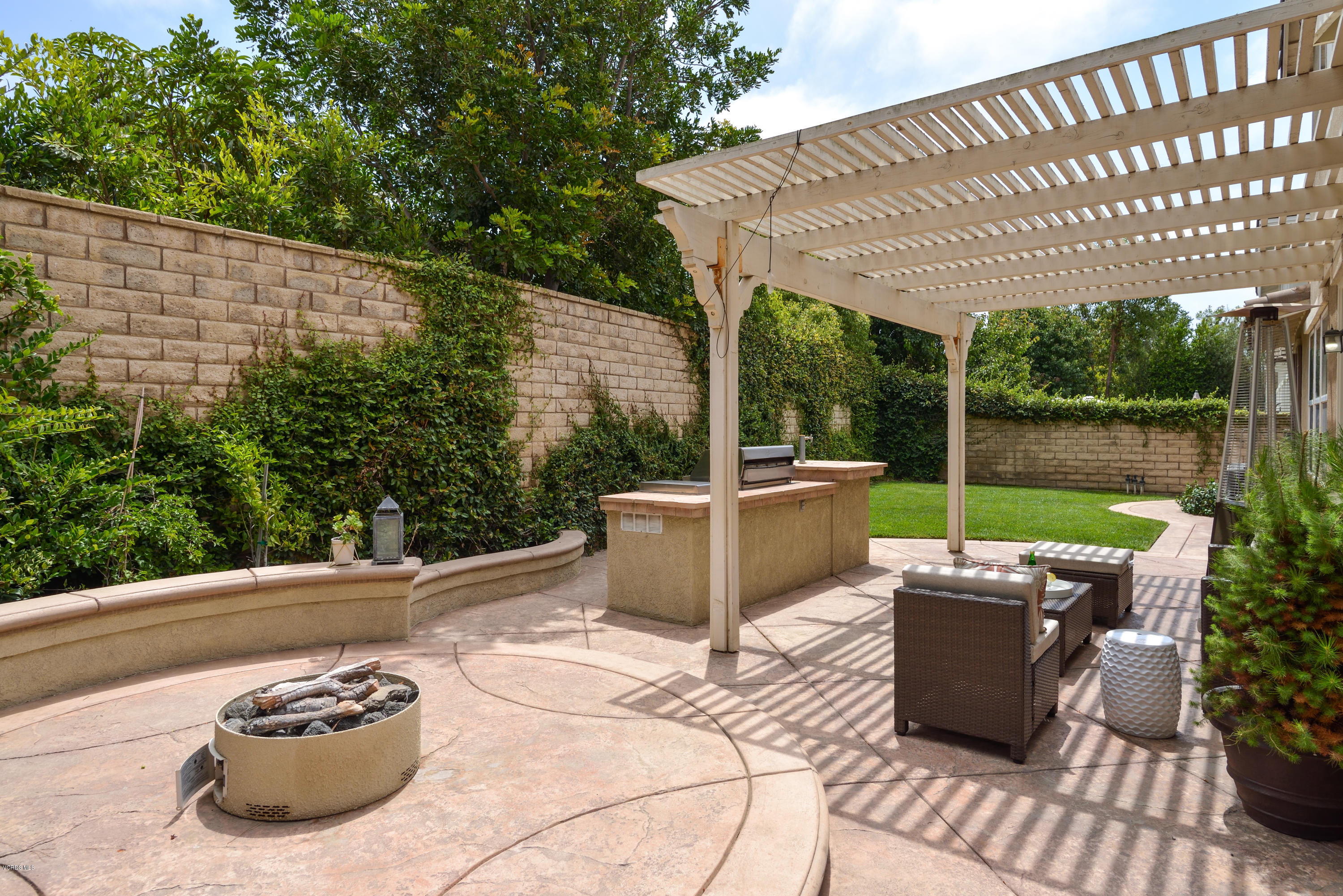 310 Spring Park Road Camarillo, CA 93012 - Photo 7 of 48 a view of a patio with table and chairs potted plants with a fire pit