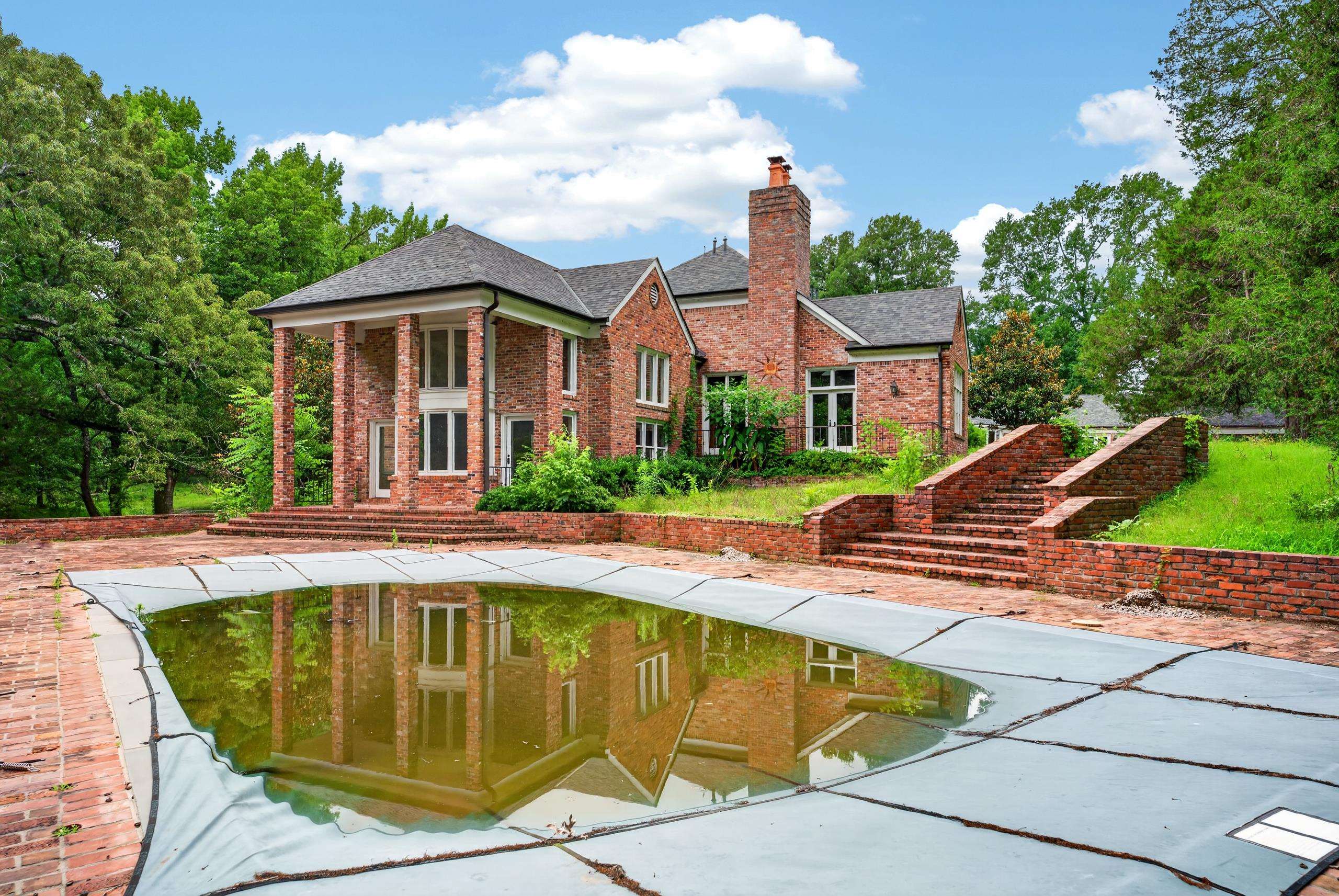 530 West Raines Road Memphis, TN 38109 - Photo 3 of 38 Brick exterior with a covered pool, multiple outdoor brick staircases, and a stately portico with tall columns