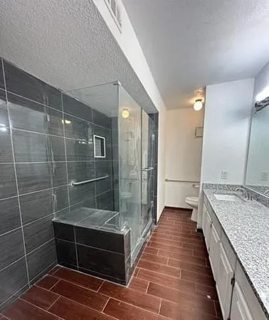 a bathroom with a double vanity sink toilet and shower