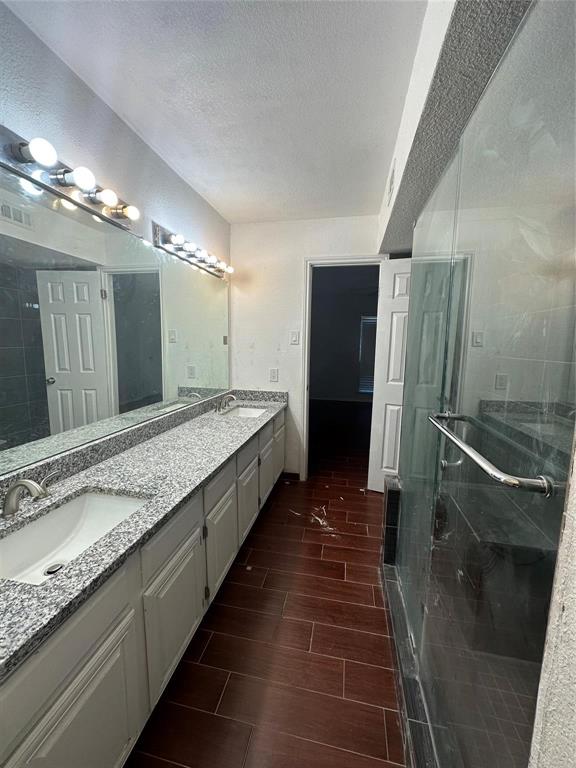 15221 Berry Trail, Unit 1003 Dallas, TX 75248 - Photo 14 of 17 a large bathroom with a large mirror and shower