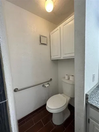 a room with wooden floor washer and dryer