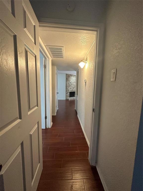 15221 Berry Trail, Unit 1003 Dallas, TX 75248 - Photo 4 of 17 a view of a hallway with wooden floor and staircase
