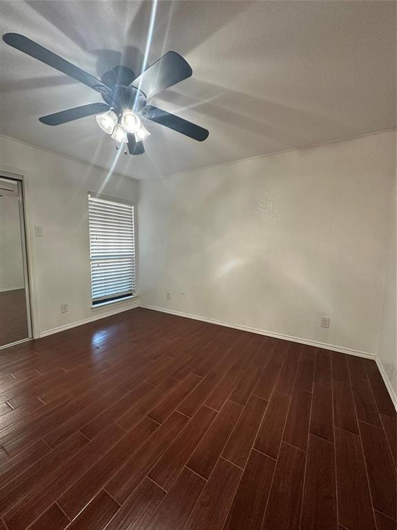 15221 Berry Trail, Unit 1003 Dallas, TX 75248 - Photo 5 of 17 an empty room with wooden floor fan and windows