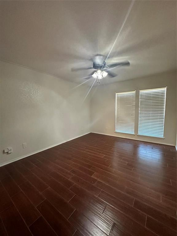 15221 Berry Trail, Unit 1003 Dallas, TX 75248 - Photo 6 of 17 a view of a room with wooden floor and fan
