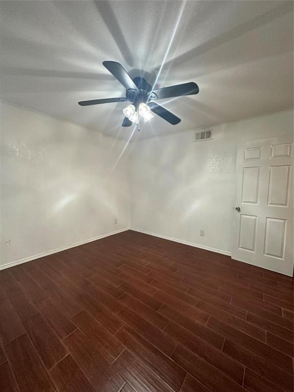 15221 Berry Trail, Unit 1003 Dallas, TX 75248 - Photo 8 of 17 an empty room with wooden floor fan and windows