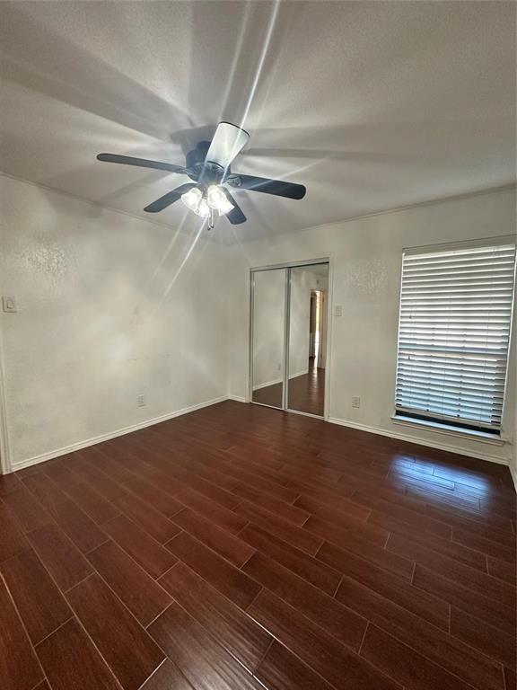 15221 Berry Trail, Unit 1003 Dallas, TX 75248 - Photo 9 of 17 a view of an empty room with wooden floor and a window