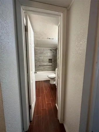 a bathroom with a granite countertop double vanity and a shower
