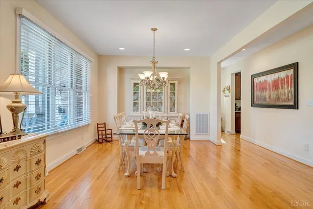a view of a dining room with furniture a chandelier and wooden floor