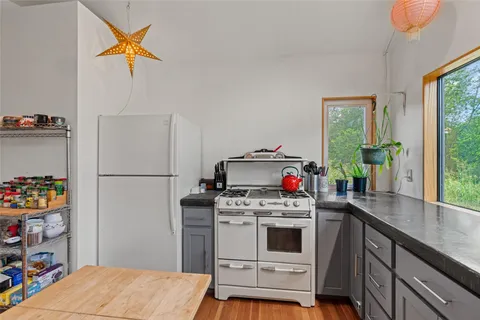 a kitchen with a stove a fridge and a refrigerator