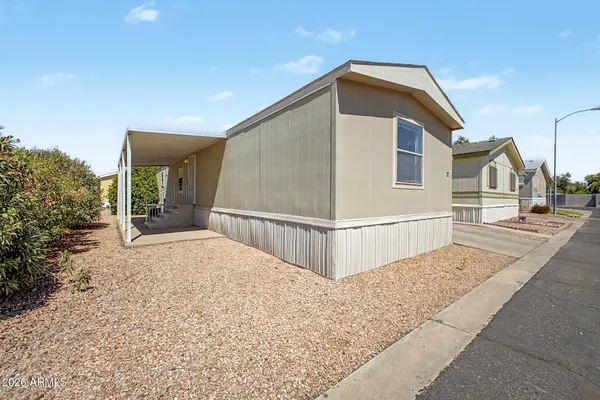 a front view of a house with white fence