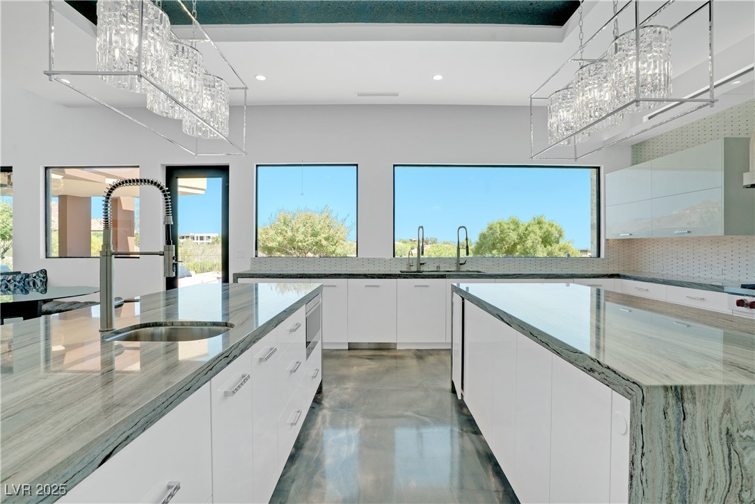 10 Ridge Blossom Road Las Vegas, NV 89135 - Photo 12 of 69 Kitchen featuring white cabinetry, a chandelier, dark stone counters, modern cabinets, and recessed lighting