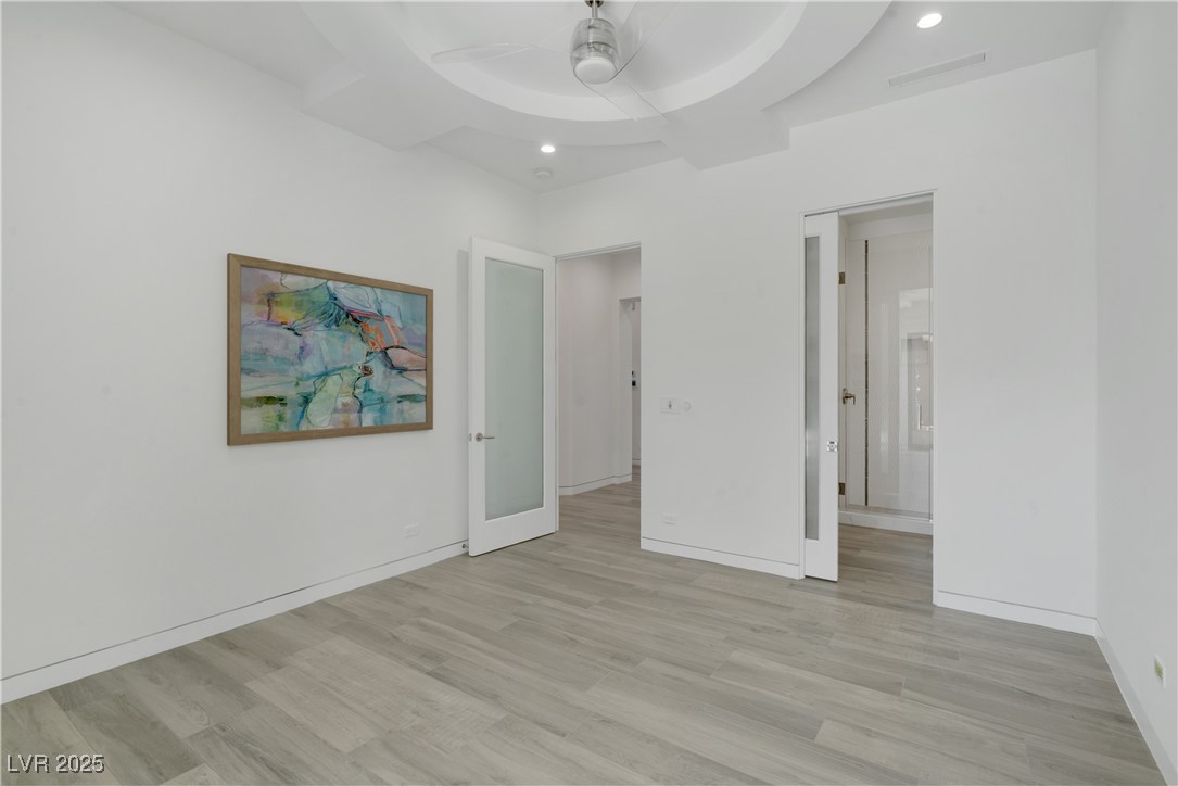 10 Ridge Blossom Road Las Vegas, NV 89135 - Photo 42 of 69 Unfurnished bedroom featuring light wood-style flooring, a ceiling fan, recessed lighting, and ensuite bath
