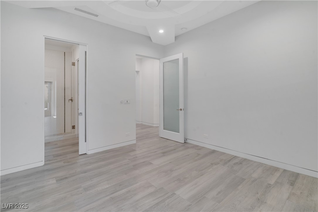 10 Ridge Blossom Road Las Vegas, NV 89135 - Photo 48 of 69 Unfurnished bedroom with light wood-style floors and ensuite bath