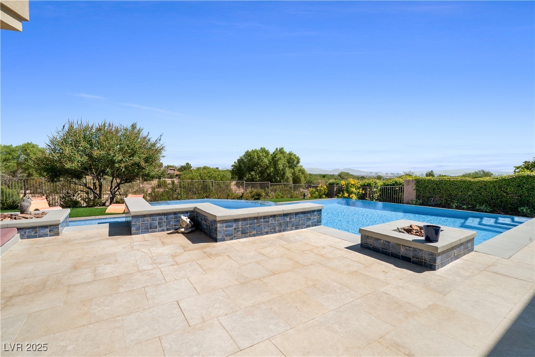 10 Ridge Blossom Road Las Vegas, NV 89135 - Photo 57 of 69 View of swimming pool with a patio, a fenced backyard, and a pool with connected hot tub