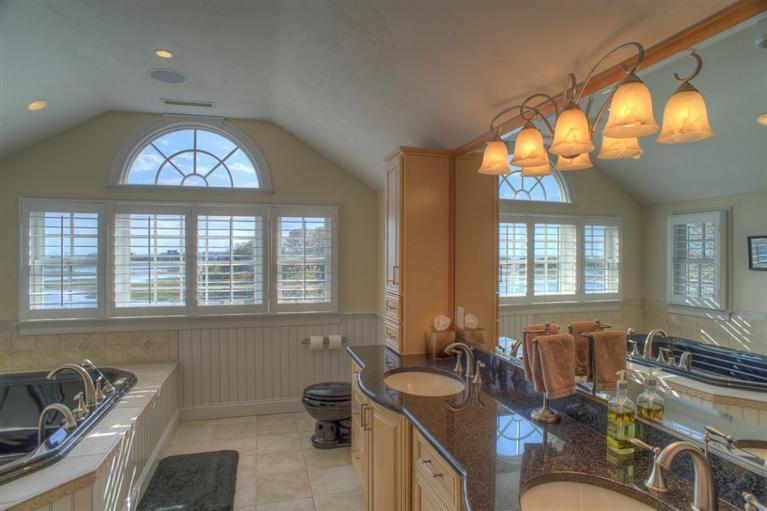 500 Elliott Road Centerville, MA 02632 - Photo 21 of 35 a bathroom with a tub a sink and a large mirror