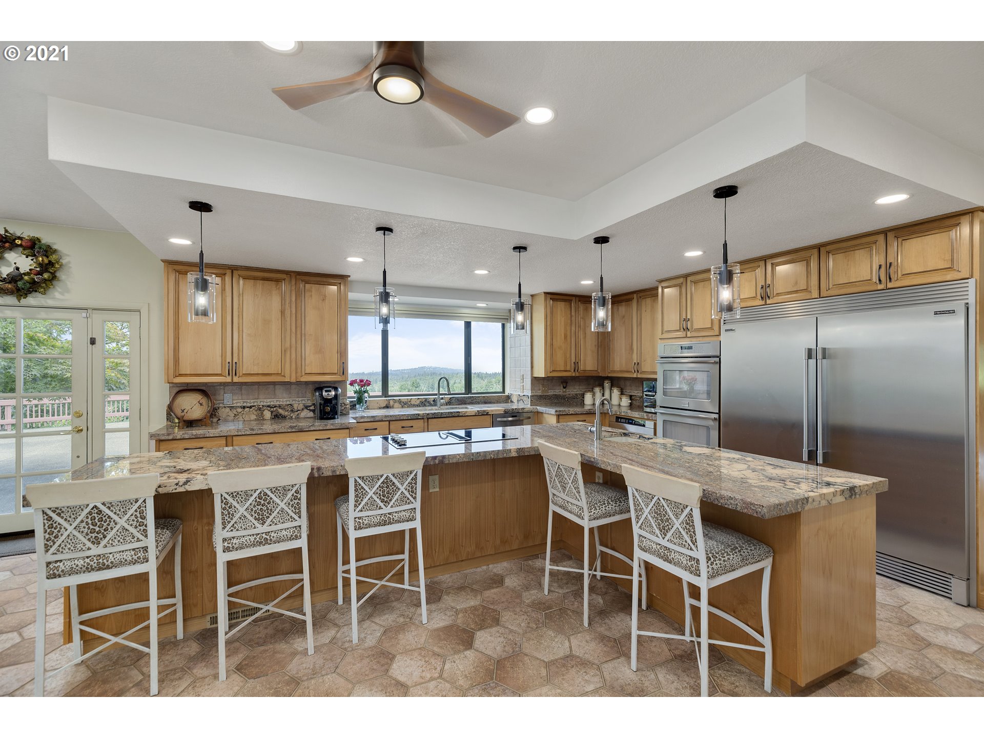201 Northeast Salzman Road Corbett, OR 97019 - Photo 11 of 32 a kitchen with a dining table chairs cabinets and stainless steel appliances